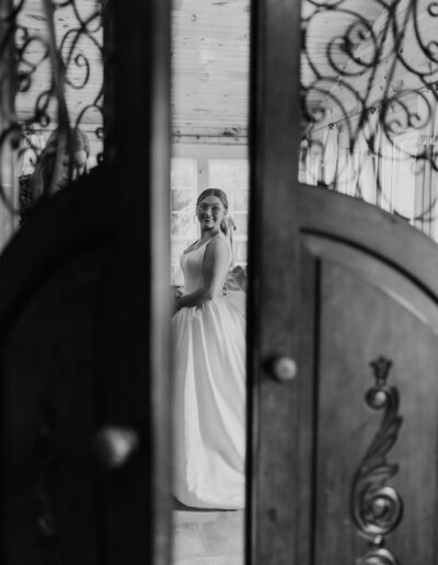 Bride looking into a large mirror