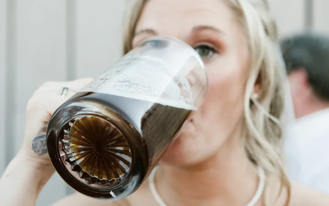 Bride drinking from a glass mug.